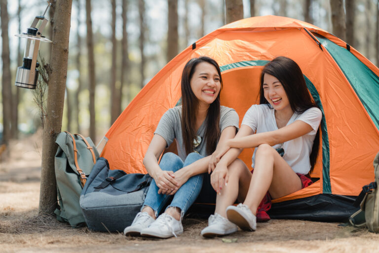 lgbtq lesbian women couple camping picnic together forest